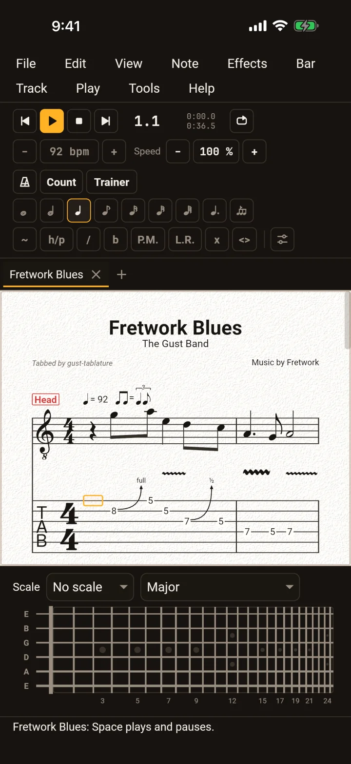 GuitarLab on an iPhone in the dark theme, the score on its light page and the toolbar's keys around it.